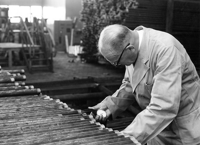 Man performing inspection on items back in the day in black and white