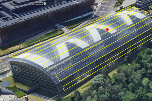 Aerial view of a modern glass-roofed building, part of the European Court of Justice complex in Luxembourg, surrounded by trees and adjacent roads