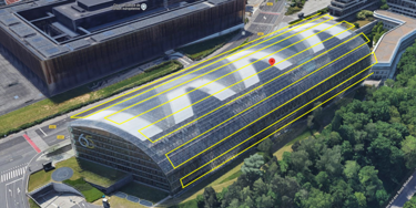 Aerial view of the European Court of Justice building with a unique glass roof design, surrounded by greenery in Luxembourg