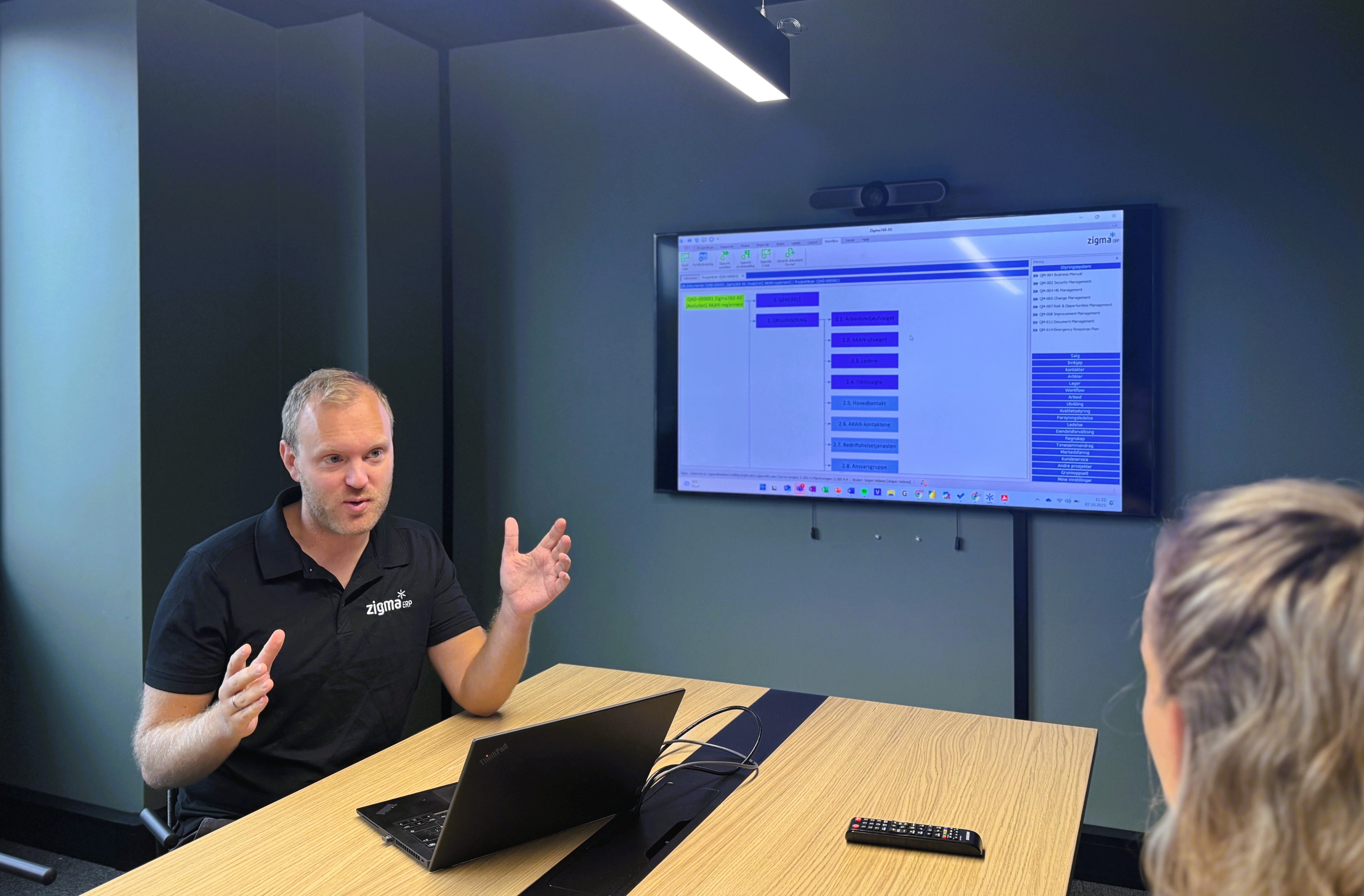 Man in meeting rom showing erp system
