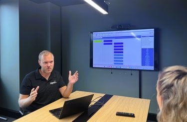 Man in meeting rom showing erp system