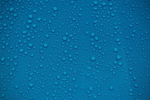 clear water drops on blue background