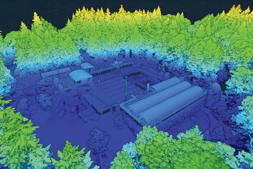 Aerial view of a LiDAR-style 3D scan showing buildings surrounded by dense forest.