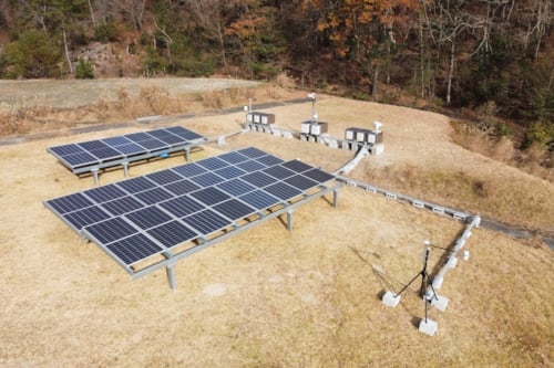 dry grass filed with solar panels