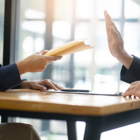 person refusing a bribe envelope