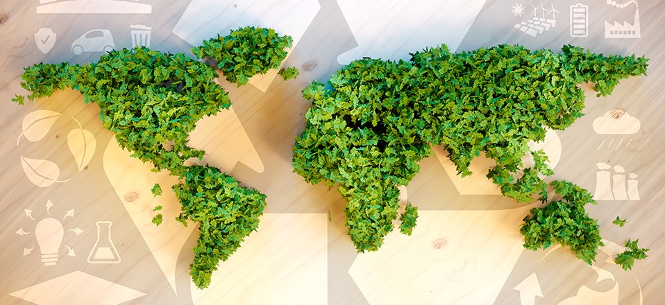 A world map made from green leaves symbolizes global sustainability and environmental awareness